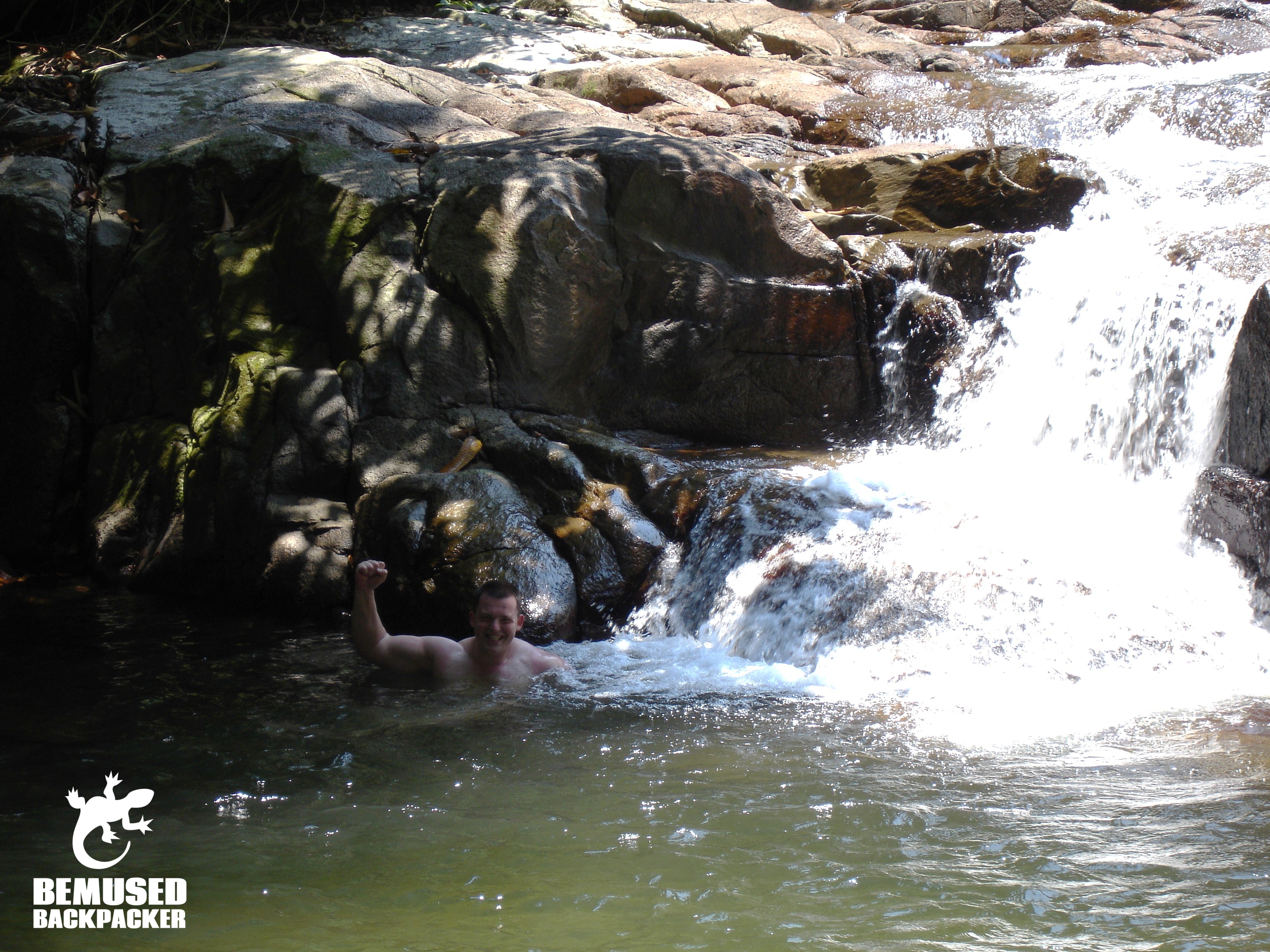Getting a natural shower under a waterfall