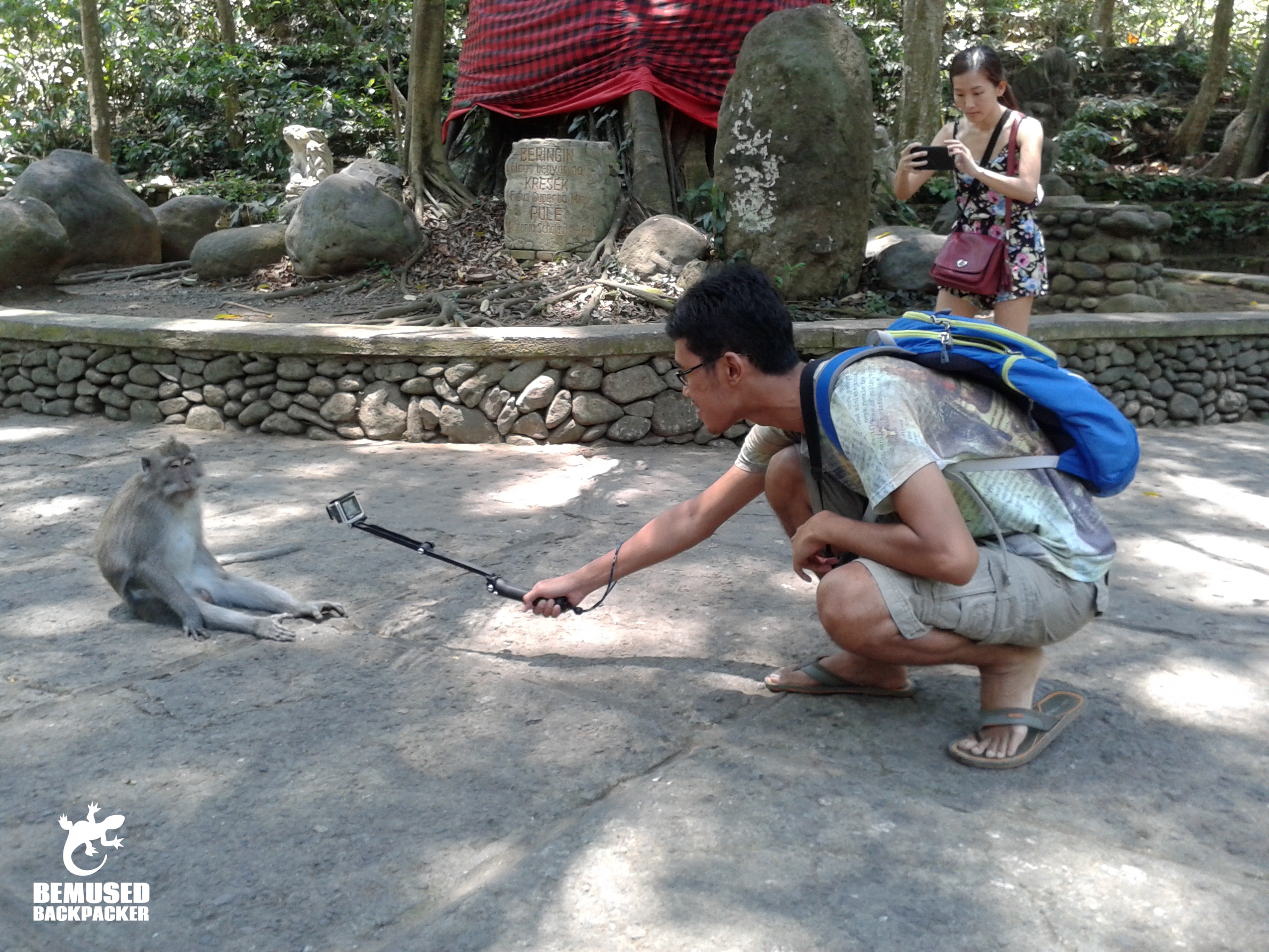 tourist using a go pro and selfie stick in the Monkey Forest, Bali