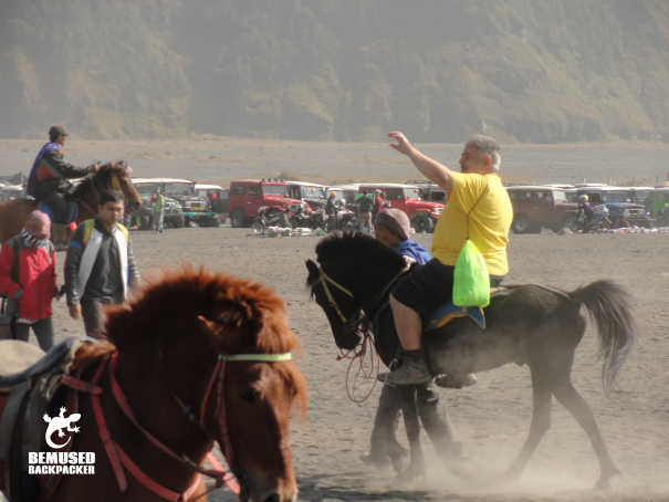 Responsible tourism riding horses sea of sand Mount Bromo Indonesia