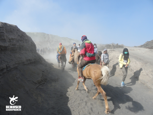 Tourists riding horses on the sea of sand Mount Bromo Indonesia