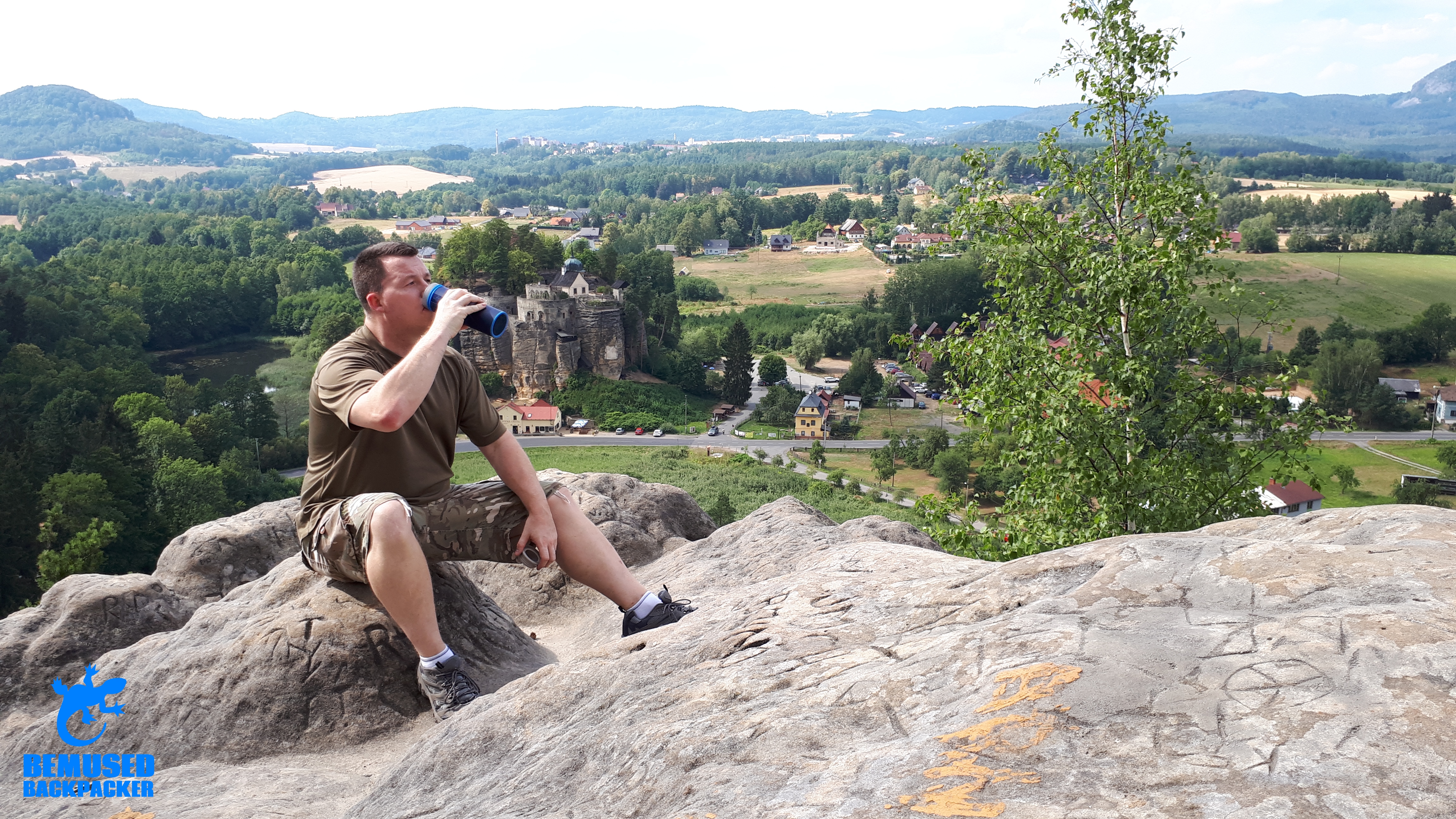 Michael Huxley Drinking from a GRAYL water bottle on a mountain