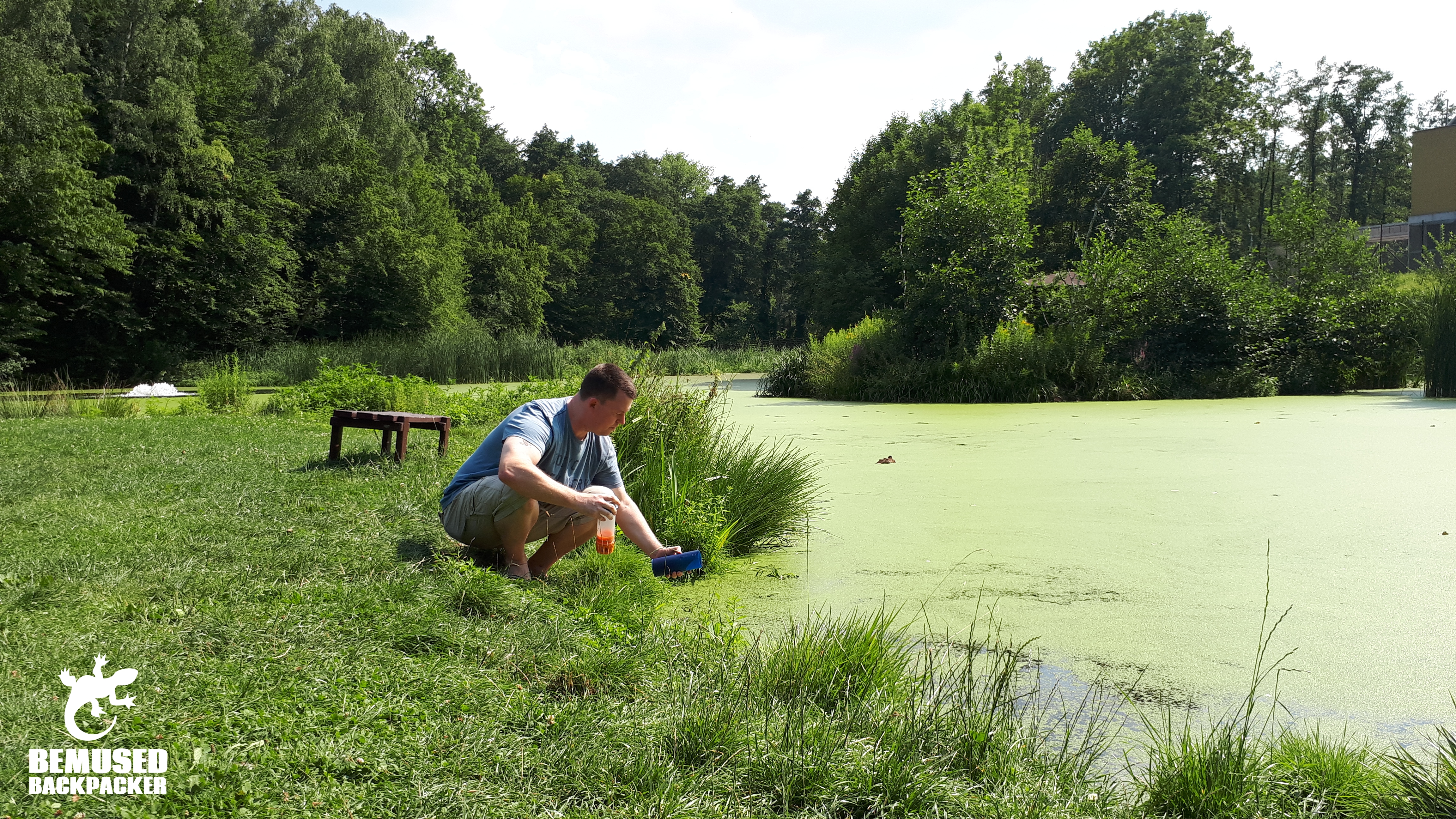 Refilling GRAYL water bottle at a lake