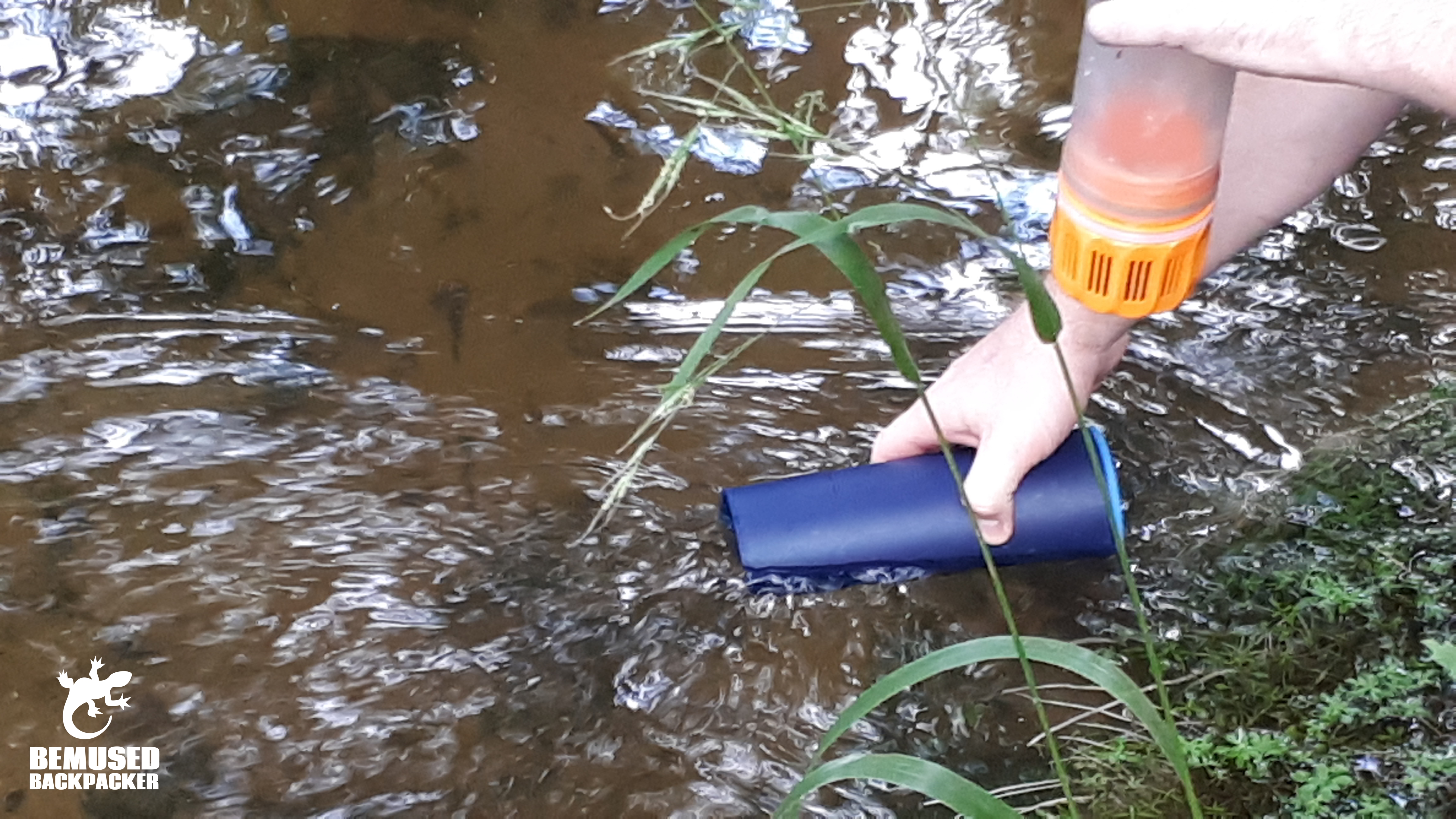Refilling GRAYL water bottle in a stream