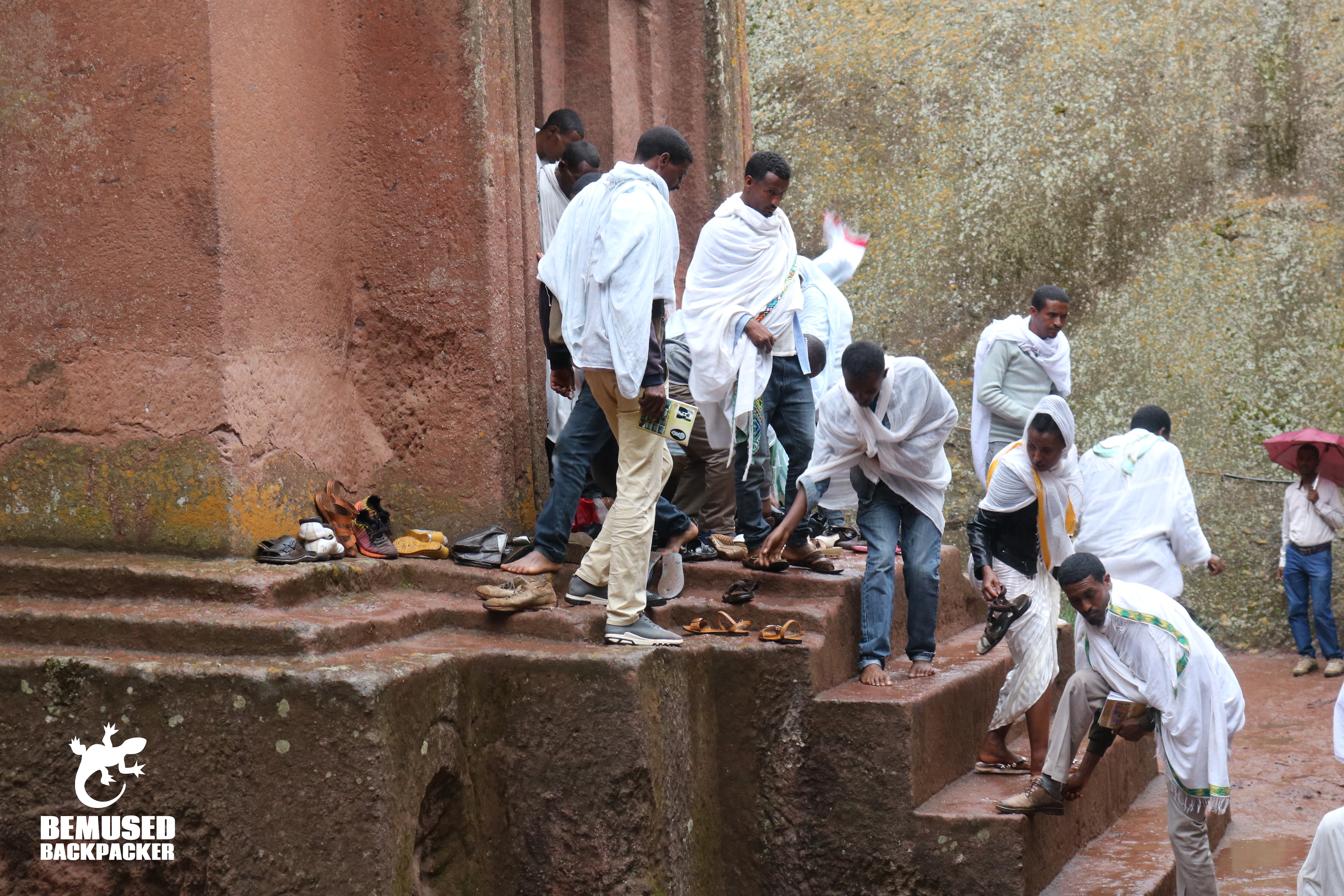 rock hewn churches of lalibela ethiopia locals taking off shoes outside of church